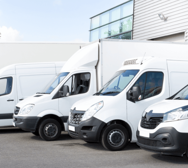 several-vans-and-trucks-parked-in-parking-lot-for-rent.png